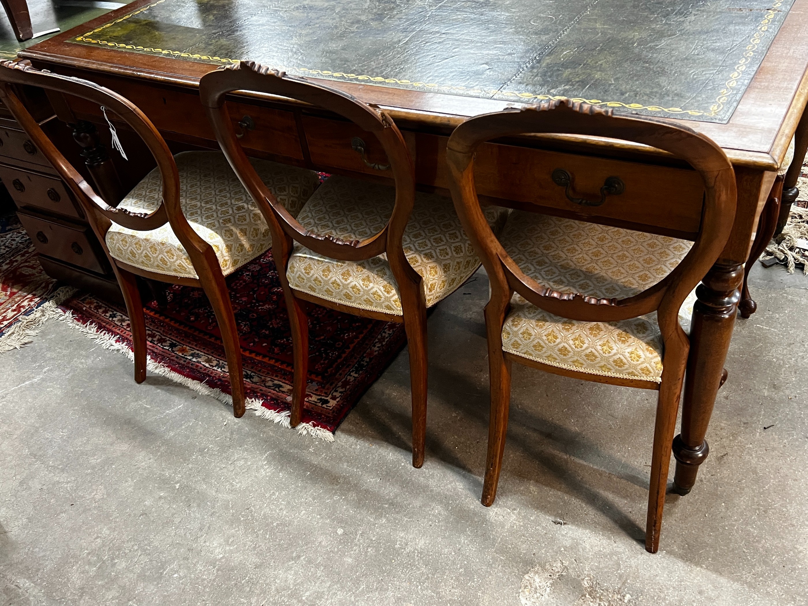 A set of six Victorian walnut balloon back dining chairs